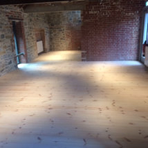 A new pine floor in the main entrance area before any finish.